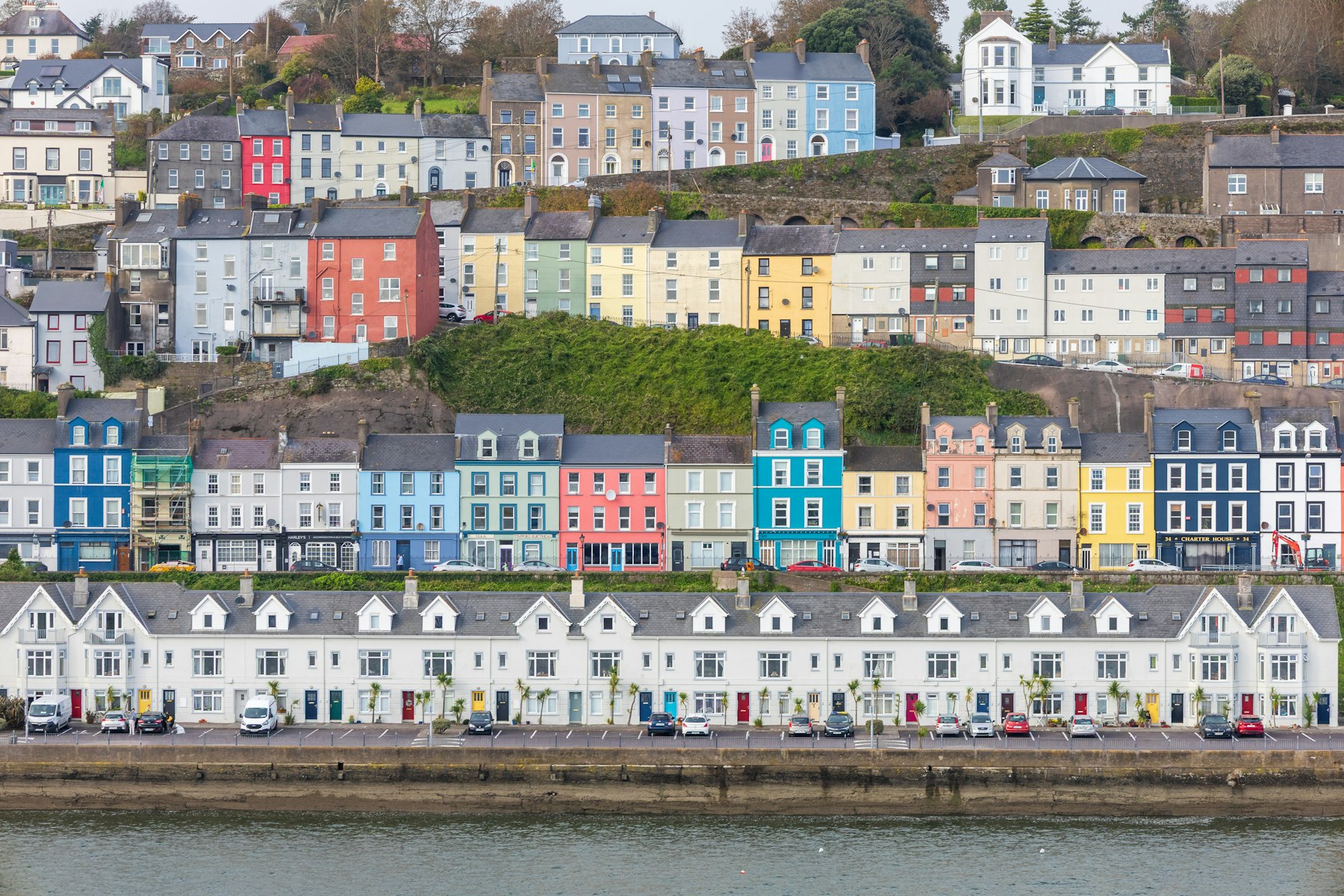 Colorful houses stacked above the waterfront at Cobh, County Cork